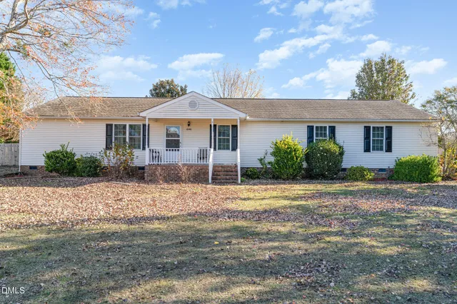 a front view of a house with a yard and a garage