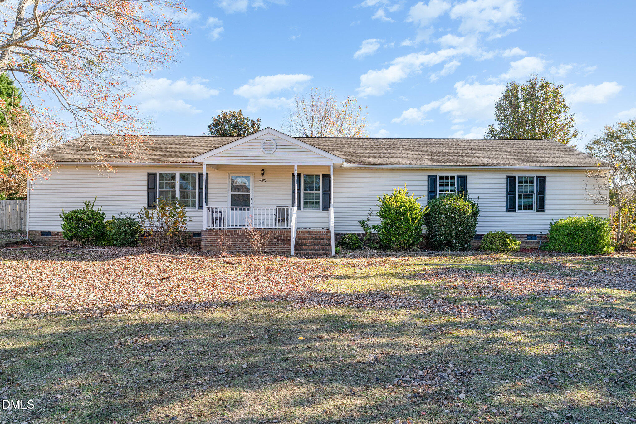 a front view of a house with a yard and a garage