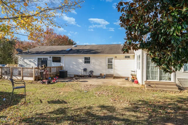 a view of a house with backyard and sitting area