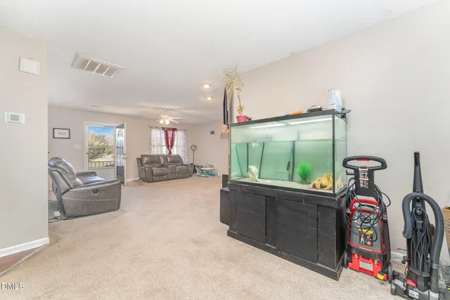 a living room with furniture a window and a flat screen tv
