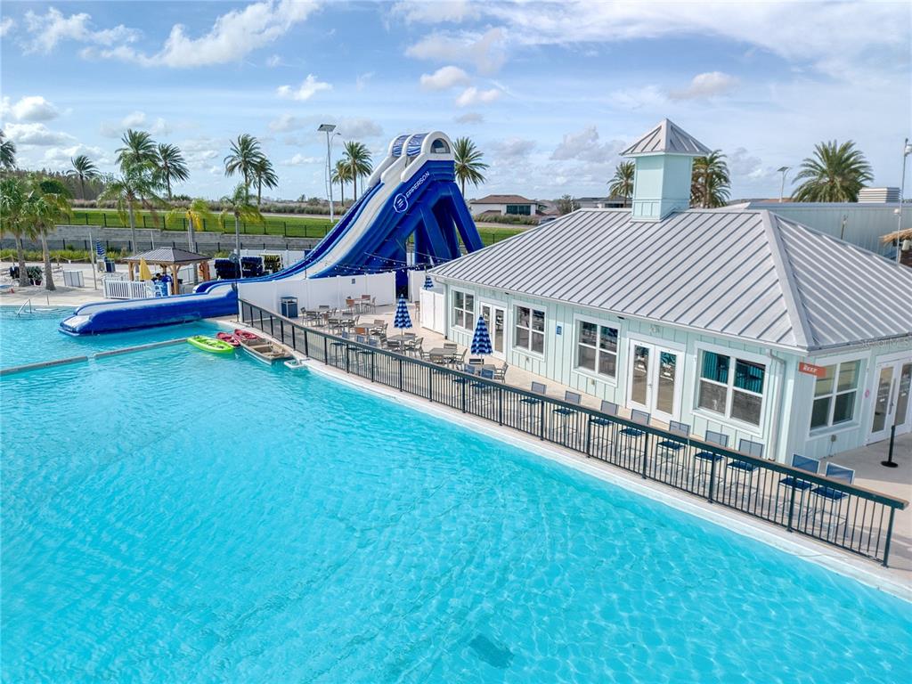 8309 Hardy Bay Loop Wesley Chapel, FL 33545 - Photo 24 of 24 a view of a house with pool and chairs