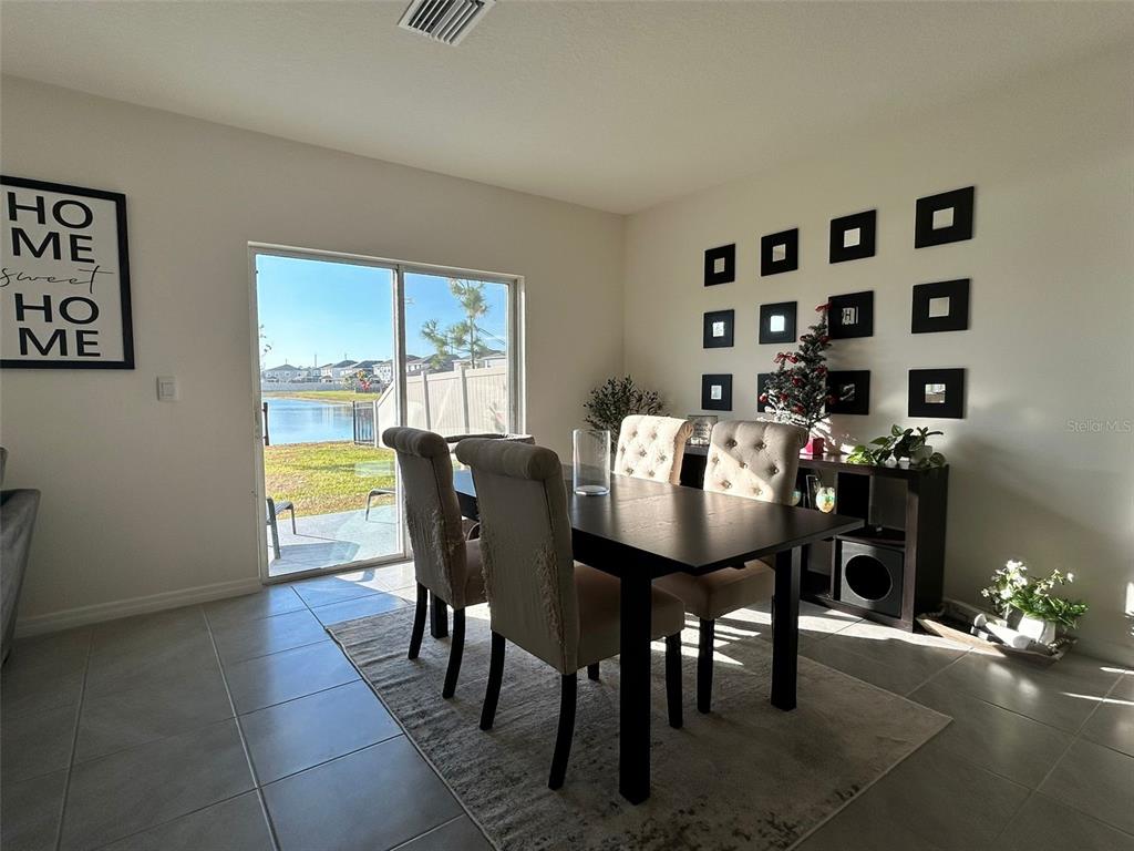 8309 Hardy Bay Loop Wesley Chapel, FL 33545 - Photo 5 of 24 a view of a dining room with furniture and chandelier