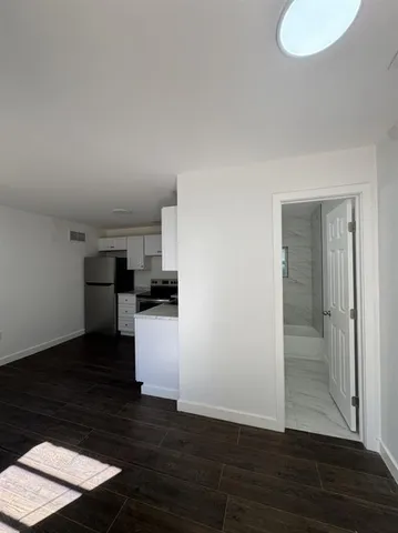 a view of kitchen and wooden floor