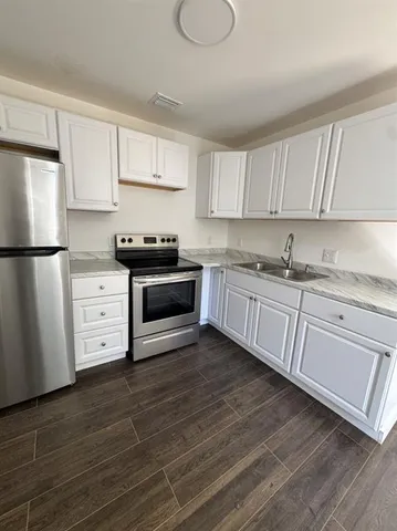 a kitchen with a white cabinets and white appliances
