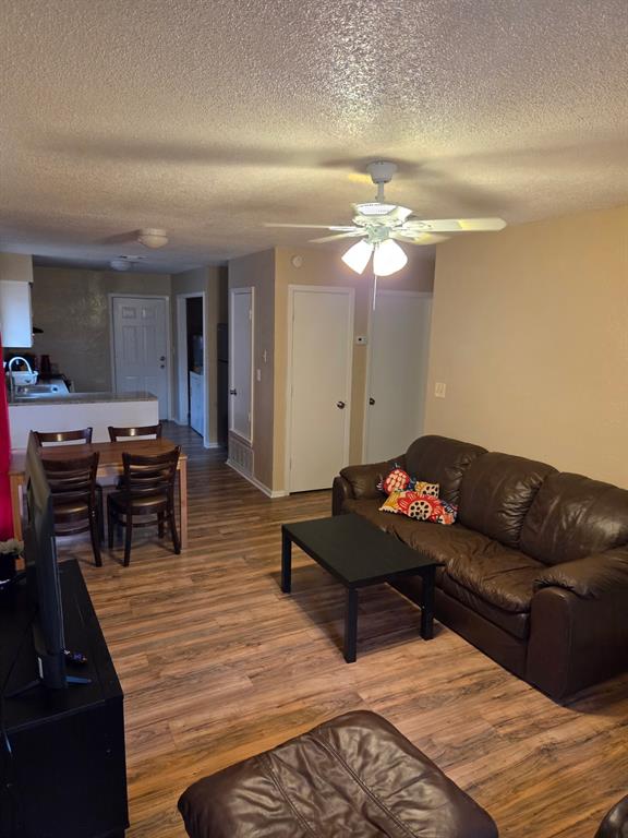 744 Sycamore Street, Unit 74 Paris, TX 75460 - Photo 1 of 10 a living room with furniture and a dining table with kitchen view