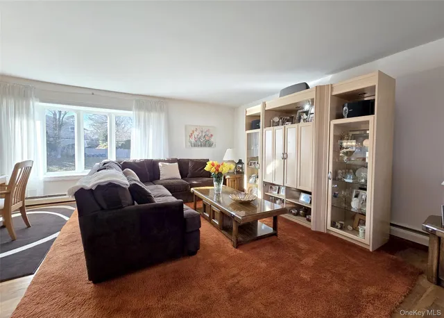a living room with furniture a ceiling fan and a window