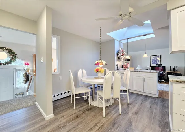 a view of a dining room with furniture and wooden floor