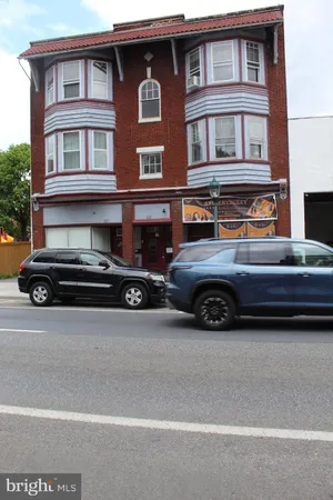a view of a car parked in front of a house