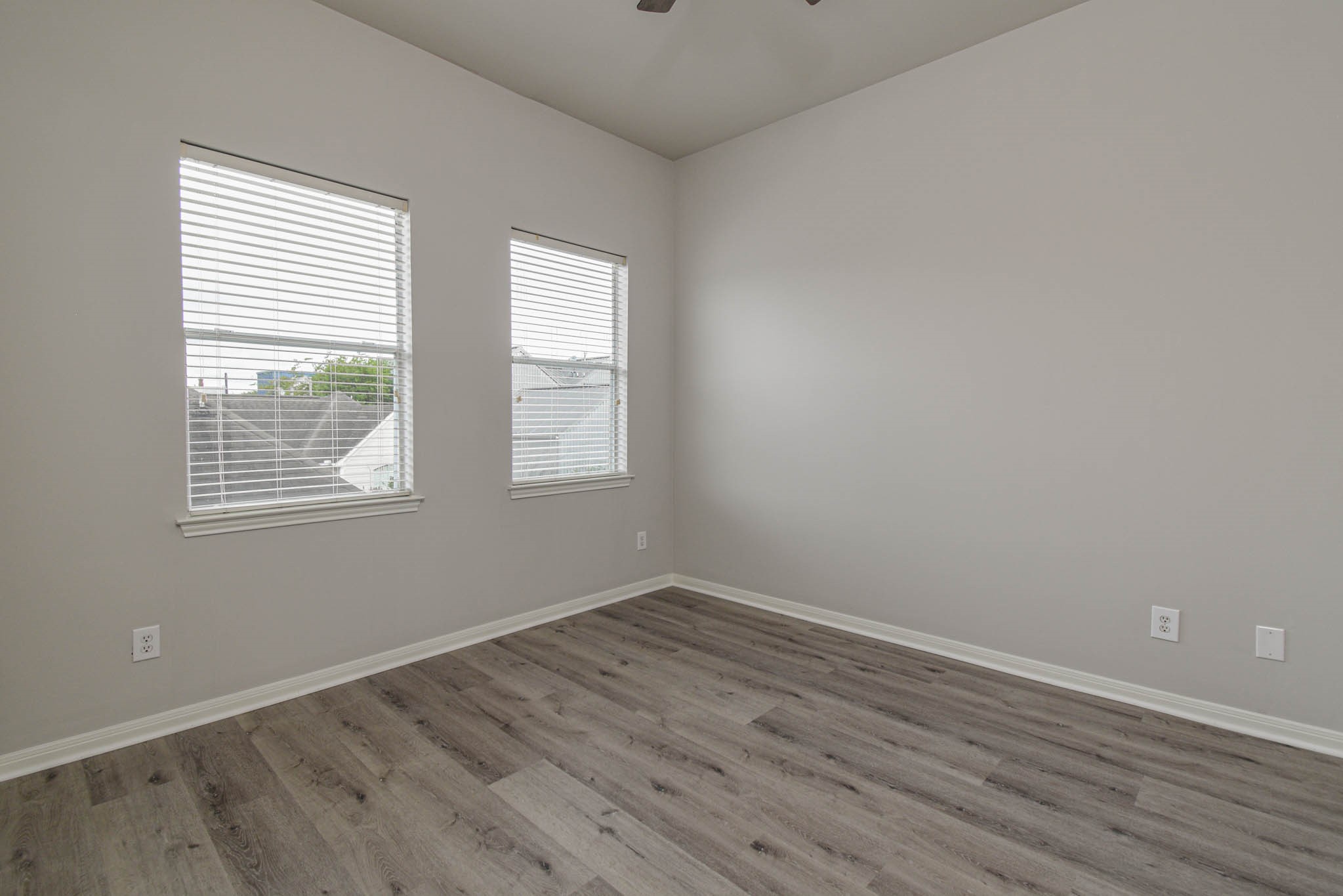 1729 Tuam Street Houston, TX 77004 - Photo 12 of 23 an empty room with wooden floor and windows