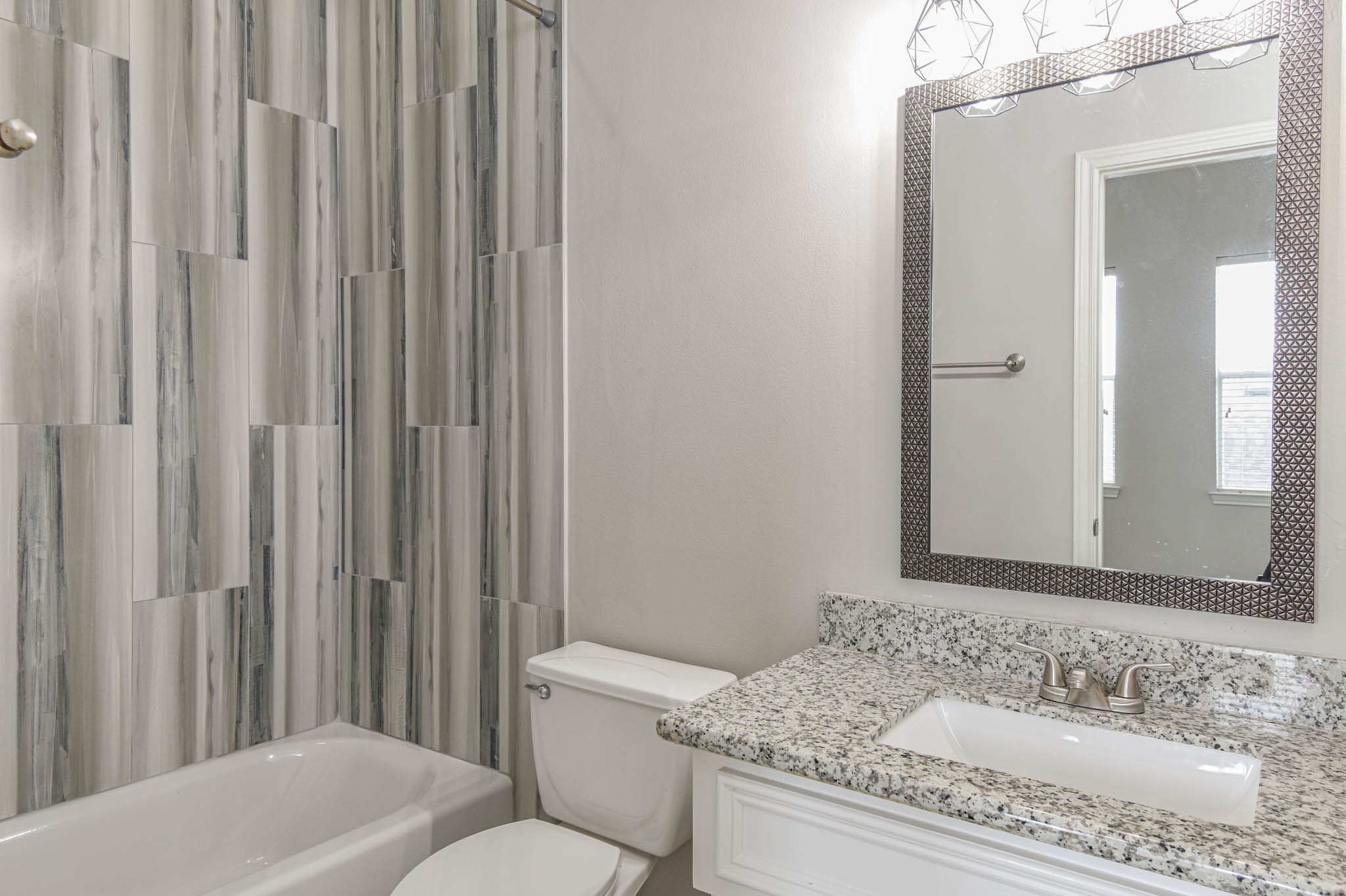1729 Tuam Street Houston, TX 77004 - Photo 20 of 23 a bathroom with a granite countertop sink and a mirror with toilet