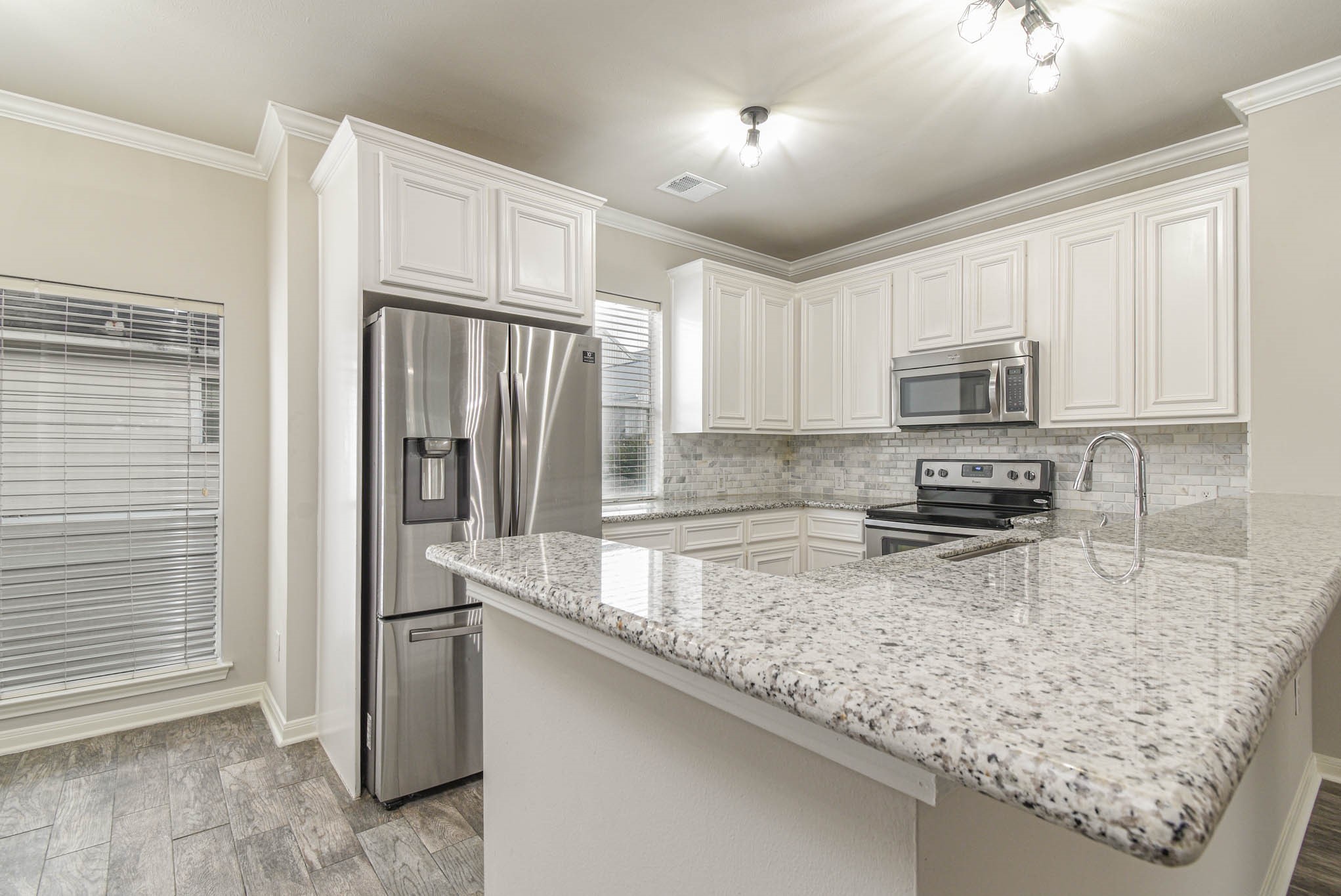 1729 Tuam Street Houston, TX 77004 - Photo 5 of 23 a kitchen with stainless steel appliances granite countertop a refrigerator a stove and a sink