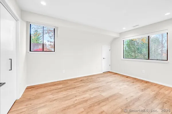 a view of an empty room with windows