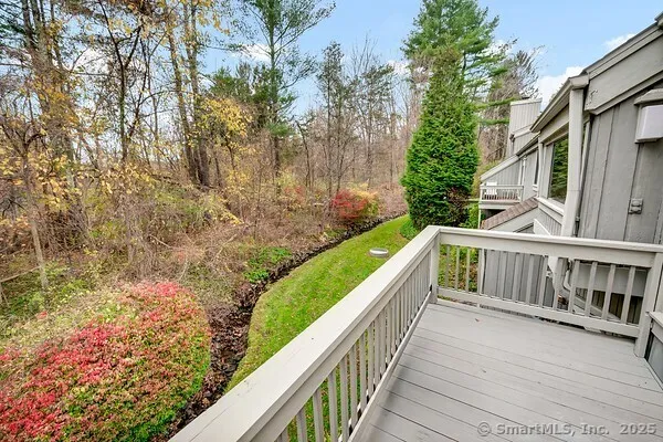 a view of balcony with wooden floor and fence