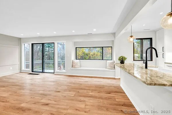 a view of a kitchen with a sink and large window