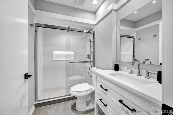 a bathroom with a toilet sink and shower