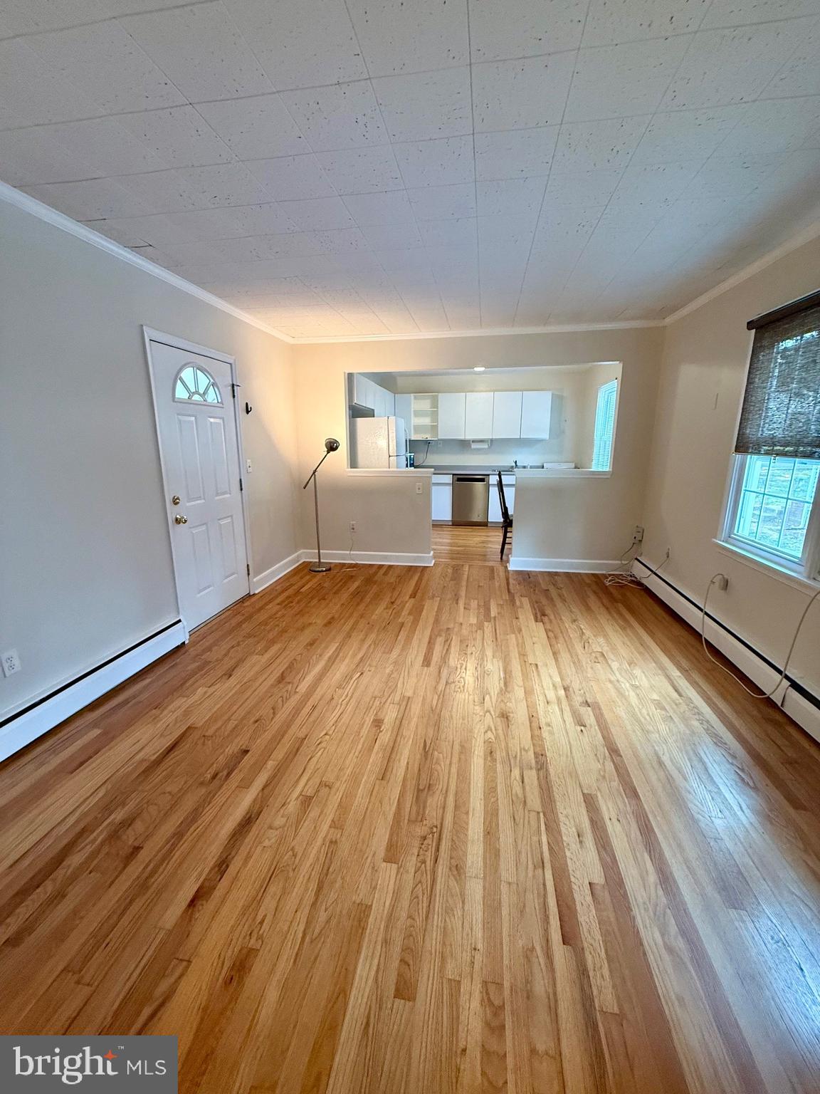225 B Dewey Drive, Unit B Annapolis, MD 21401 - Photo 5 of 15 a view of a room with wooden floor kitchen view and a window