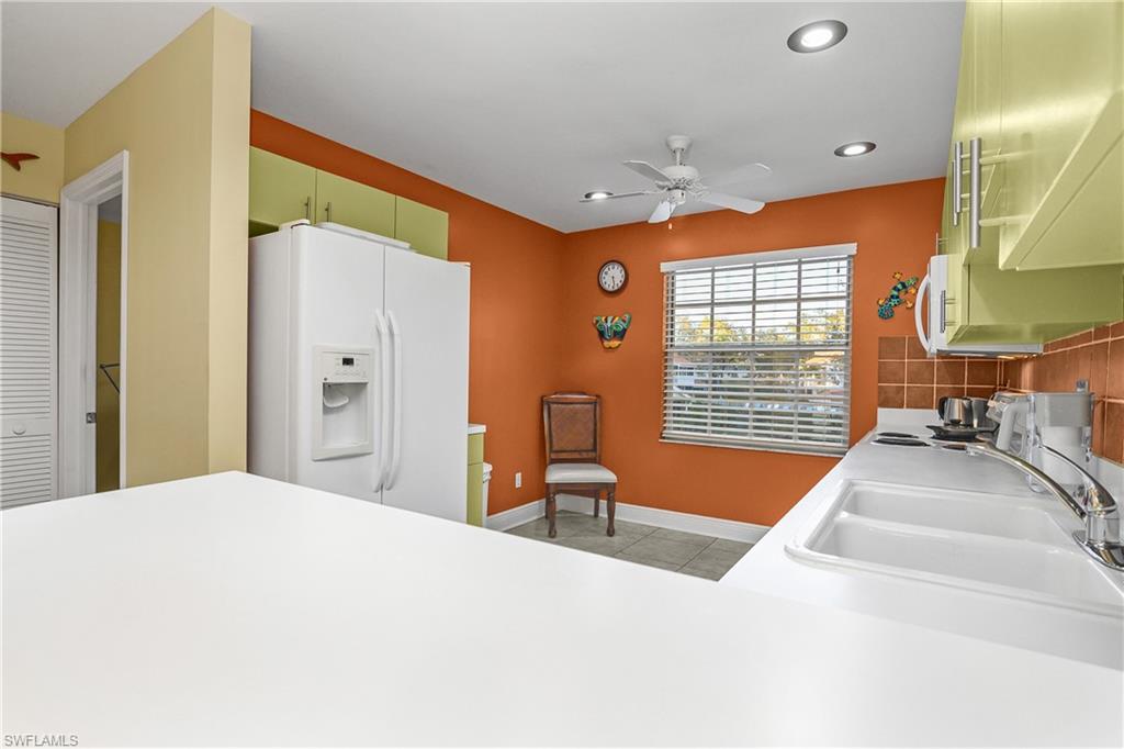 541 Windsor Square, Unit 202 Naples, FL 34104 - Photo 14 of 36 a spacious bedroom with a large bed and a large window