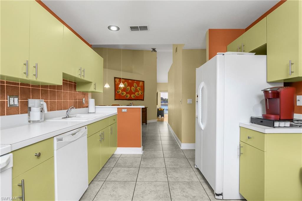 541 Windsor Square, Unit 202 Naples, FL 34104 - Photo 16 of 36 a kitchen with a refrigerator and a sink