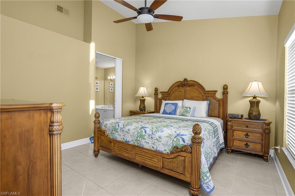 541 Windsor Square, Unit 202 Naples, FL 34104 - Photo 17 of 36 a bedroom with a bed and dresser