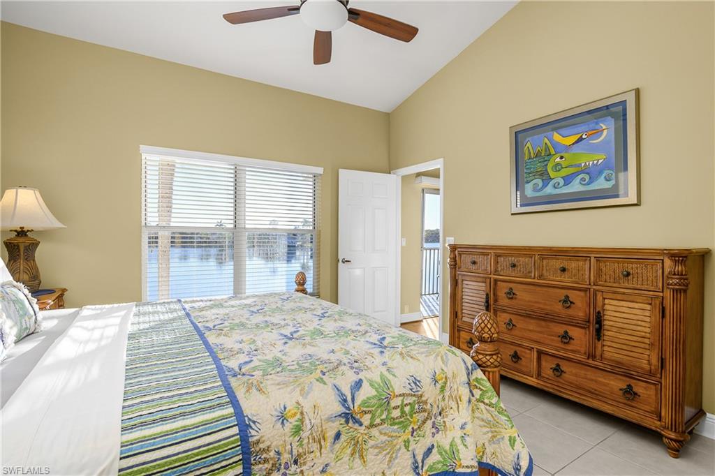 541 Windsor Square, Unit 202 Naples, FL 34104 - Photo 18 of 36 a bedroom with a bed and a painting on the wall