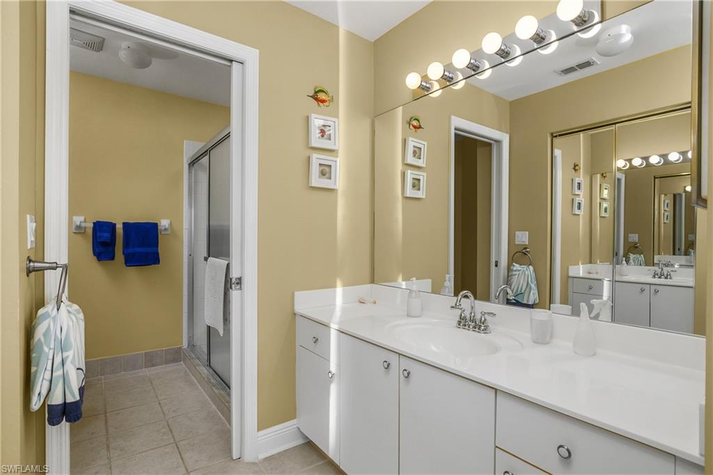 541 Windsor Square, Unit 202 Naples, FL 34104 - Photo 19 of 36 a bathroom with a sink double vanity and a mirror