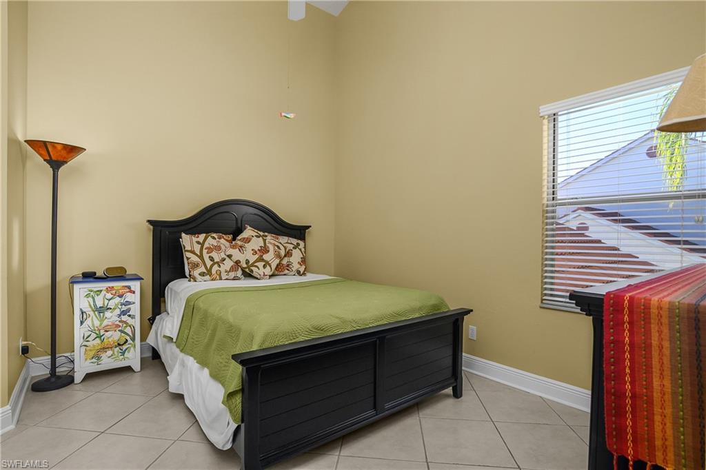 541 Windsor Square, Unit 202 Naples, FL 34104 - Photo 20 of 36 a bedroom with a bed and a window
