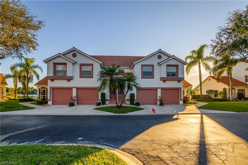 541 Windsor Square, Unit 202 Naples, FL 34104 - Photo 2 of 36 a front view of house with yard and green space