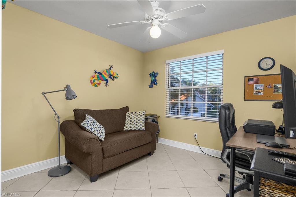 541 Windsor Square, Unit 202 Naples, FL 34104 - Photo 22 of 36 a living room with furniture and a window