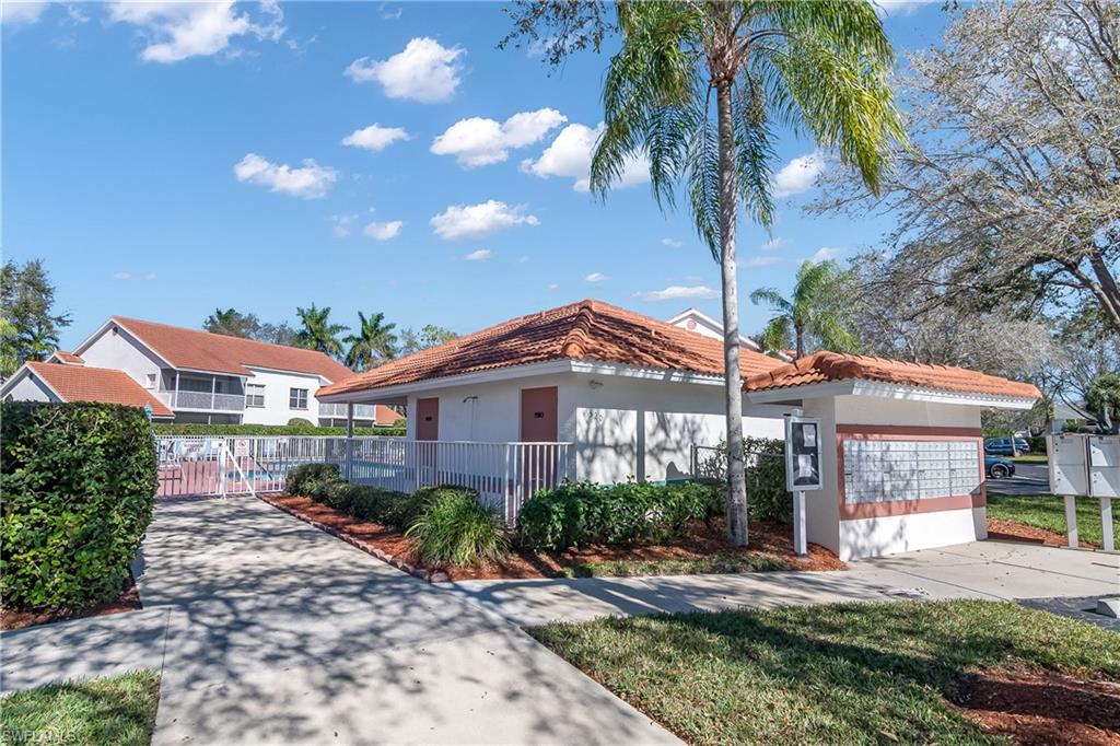 541 Windsor Square, Unit 202 Naples, FL 34104 - Photo 31 of 36 a front view of a house with garden