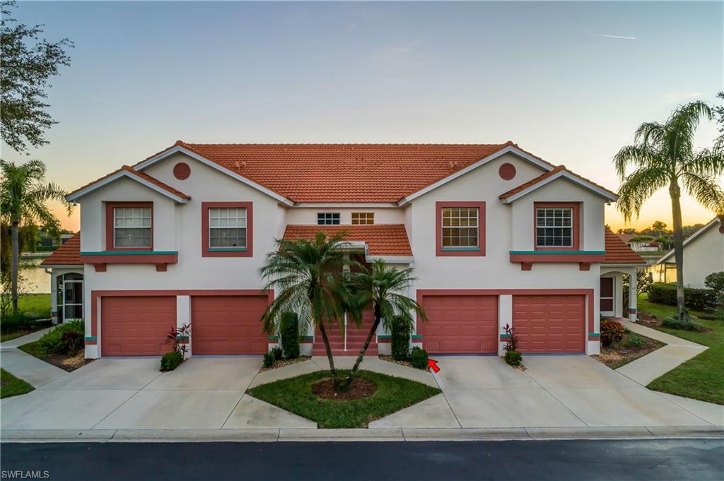 541 Windsor Square, Unit 202 Naples, FL 34104 - Photo 6 of 36 a front view of a house with a yard and garage