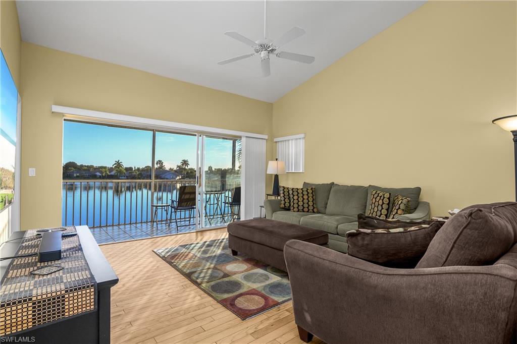 541 Windsor Square, Unit 202 Naples, FL 34104 - Photo 7 of 36 a living room with furniture and a table