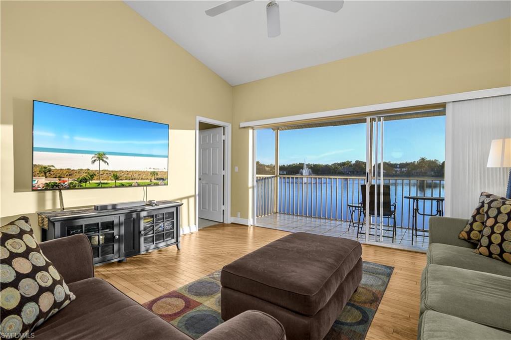 541 Windsor Square, Unit 202 Naples, FL 34104 - Photo 8 of 36 a living room with furniture and a floor to ceiling window