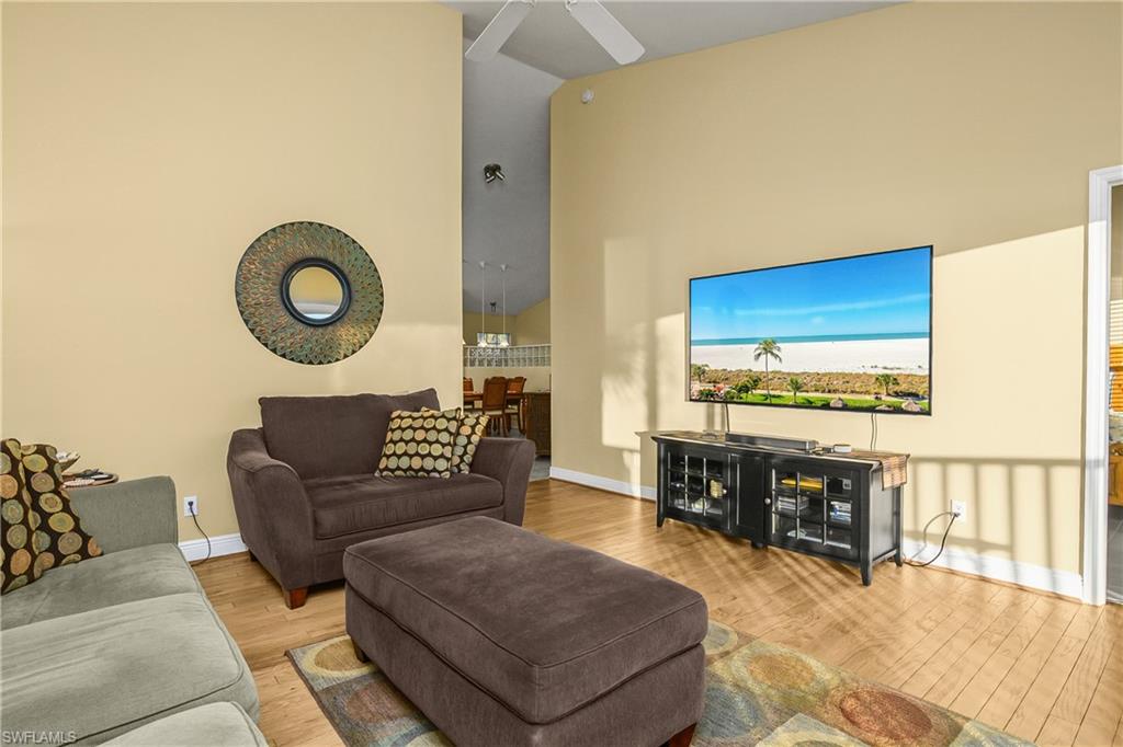 541 Windsor Square, Unit 202 Naples, FL 34104 - Photo 10 of 36 a living room with furniture and a flat screen tv