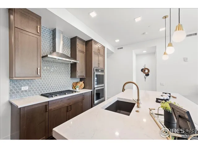 a kitchen with a sink appliances and cabinets