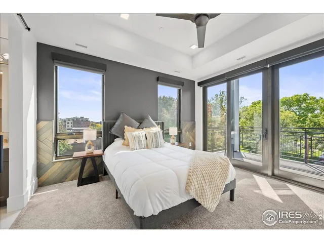 a bedroom with a large bed and a large window