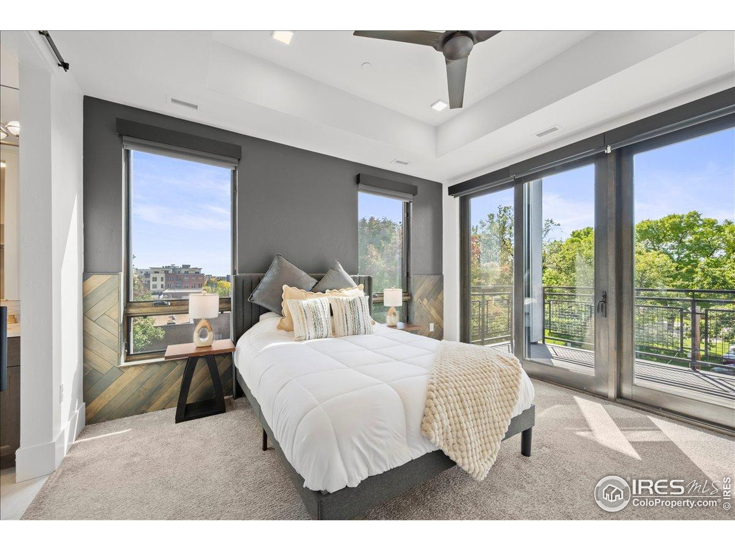 302 North Meldrum Street, Unit 313 Fort Collins, CO 80521 - Photo 16 of 36 a bedroom with a large bed and a large window