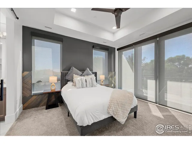 a bedroom with a large bed and a large window