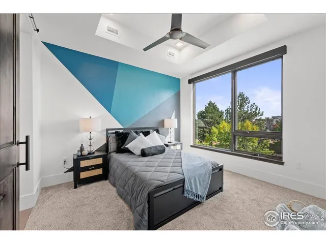 a bedroom with furniture and a large window