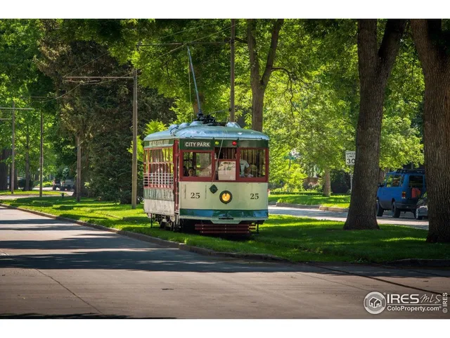 a front view of a house with a garden and trees