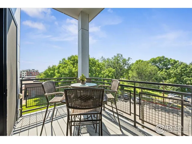 a view of balcony with chairs and wooden fence