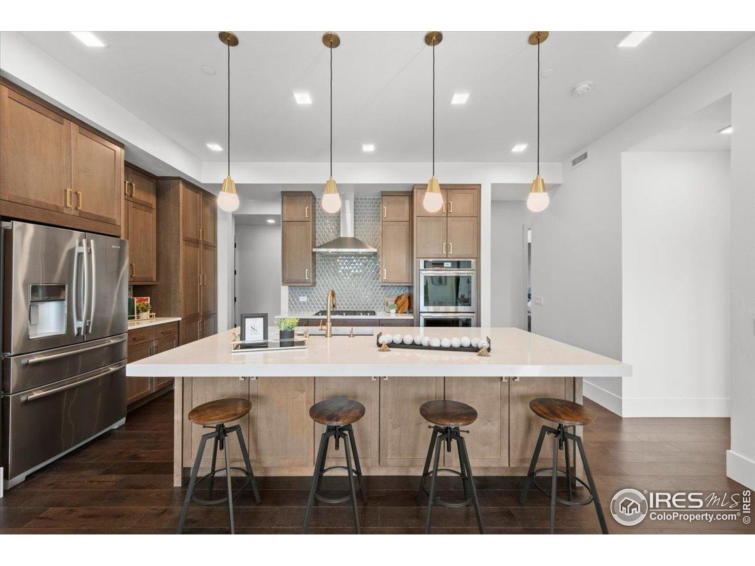 302 North Meldrum Street, Unit 313 Fort Collins, CO 80521 - Photo 7 of 36 a kitchen with kitchen island and stainless steel appliances