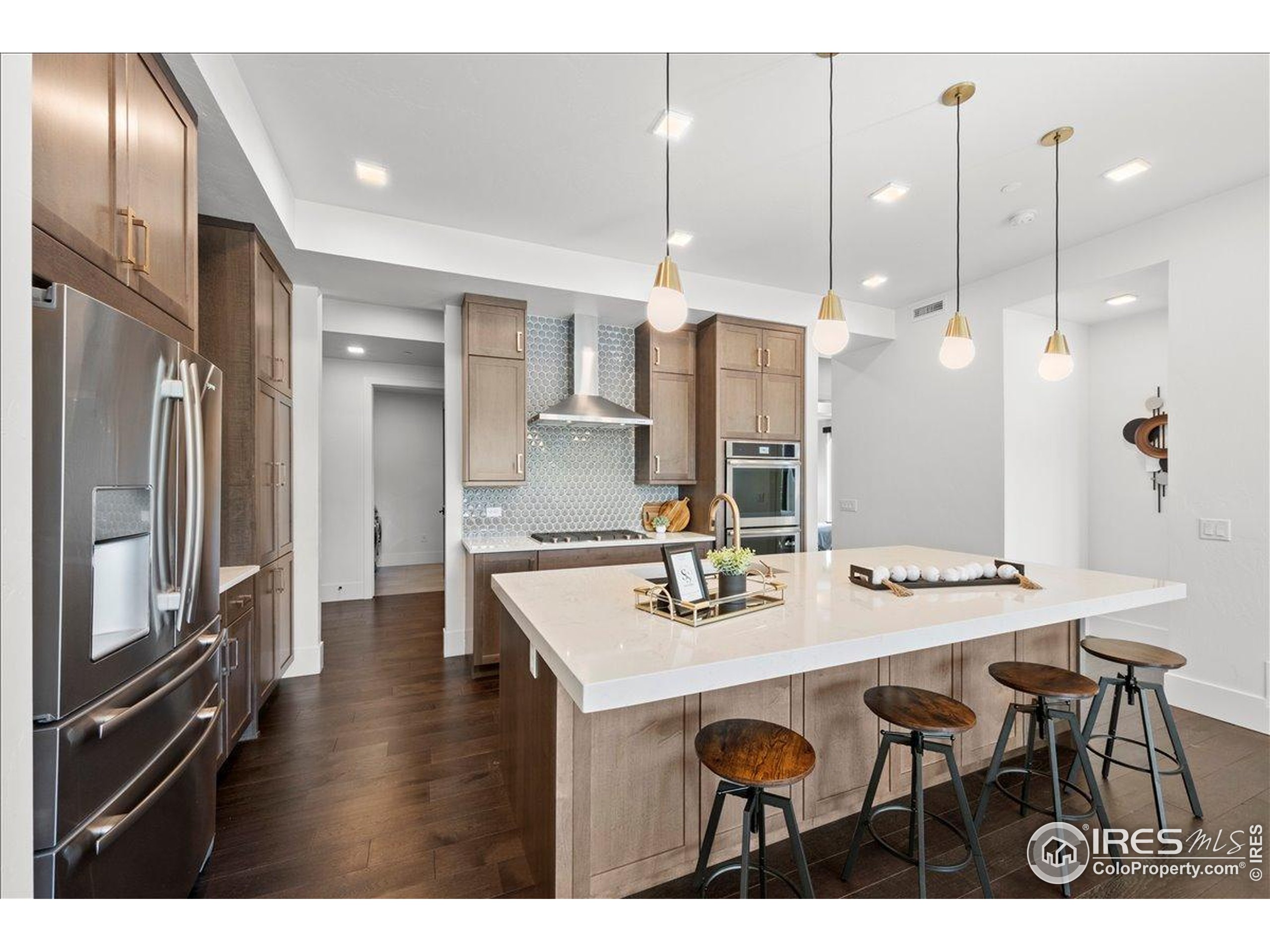 302 North Meldrum Street, Unit 313 Fort Collins, CO 80521 - Photo 10 of 36 a kitchen with granite countertop a table chairs stainless steel appliances and cabinets