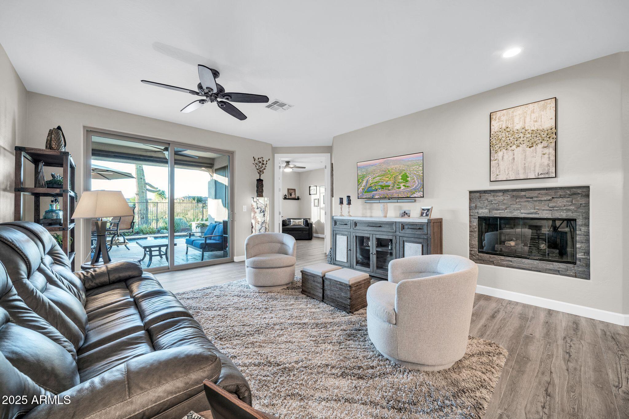 41822 North Crooked Stick Road Anthem, AZ 85086 - Photo 13 of 90 a living room with furniture and a fireplace
