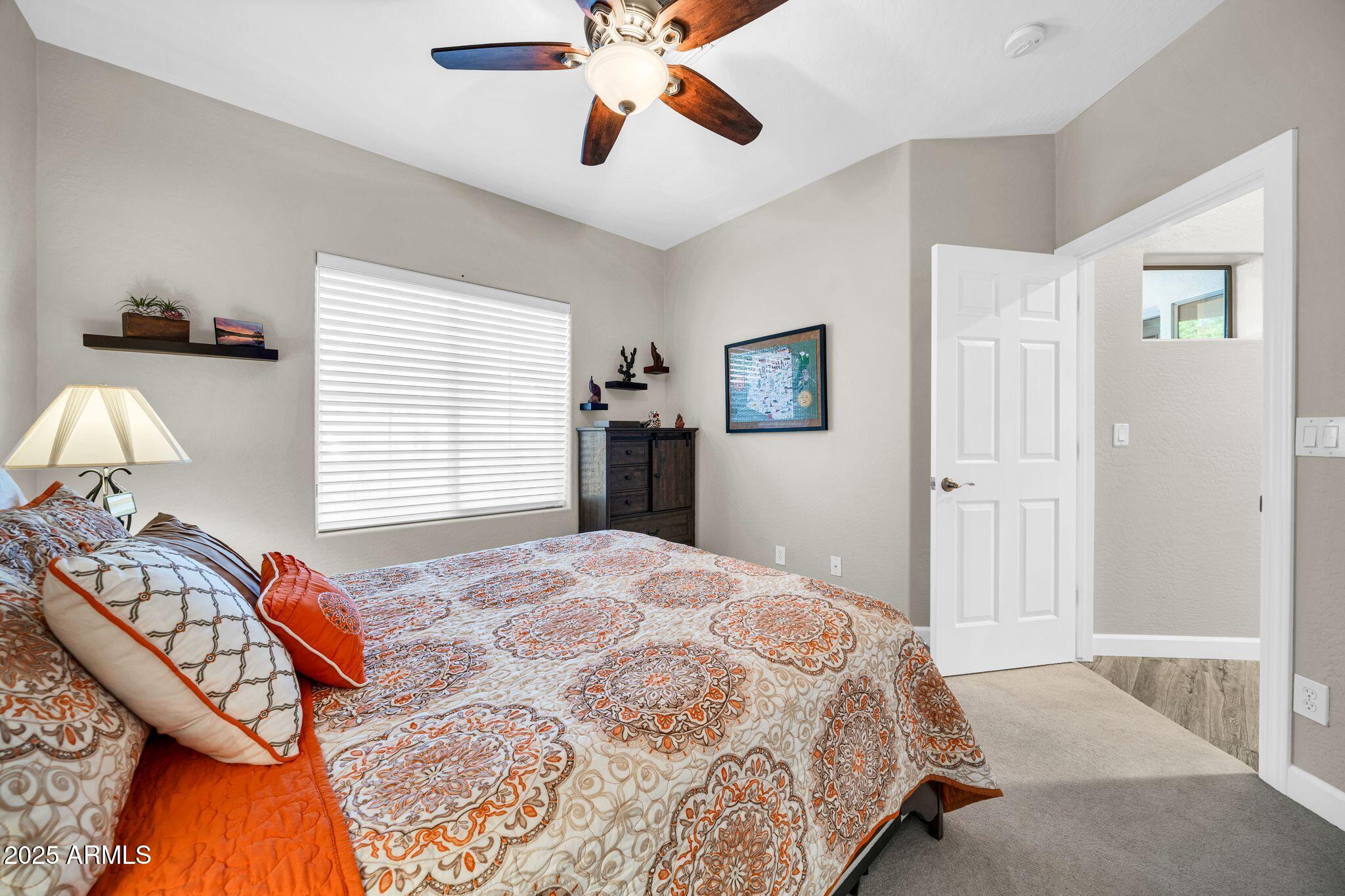 41822 North Crooked Stick Road Anthem, AZ 85086 - Photo 30 of 90 a bedroom with a bed and a chandelier