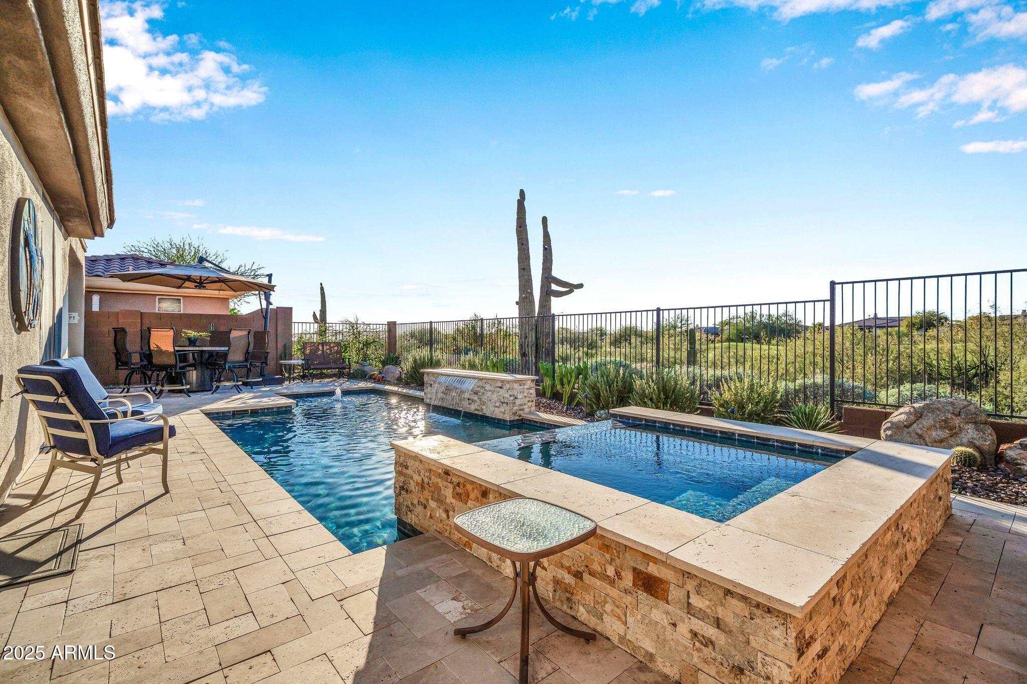 41822 North Crooked Stick Road Anthem, AZ 85086 - Photo 38 of 90 a view of a swimming pool with seating space