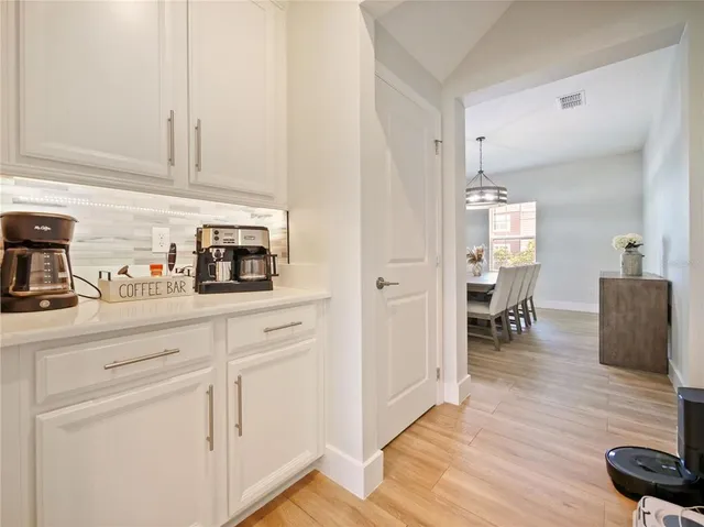 a large kitchen with a table and chairs