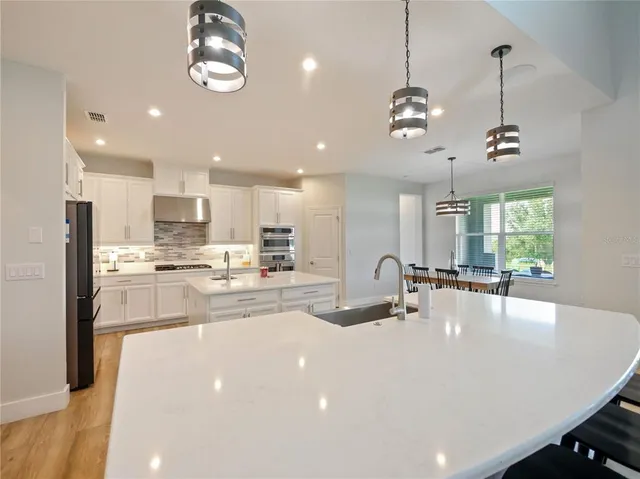 a spacious bathroom with a sink a mirror and a shower