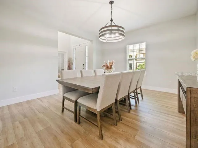 a living room with patio furniture and a garden