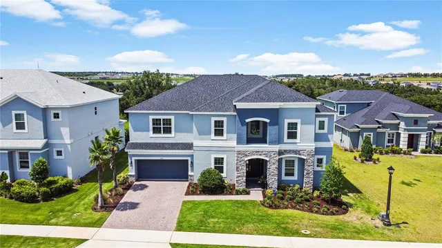 a front view of a house with a garden and plants