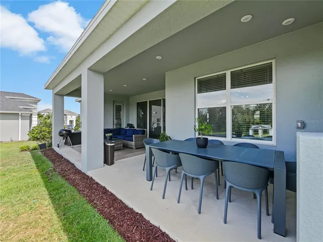 an empty room with fan and windows